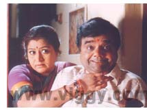 Prameela Joshai and Dwarakish in film Aptha Mitra