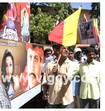 Shivrajkumar waving Kannada flag to start bike rally